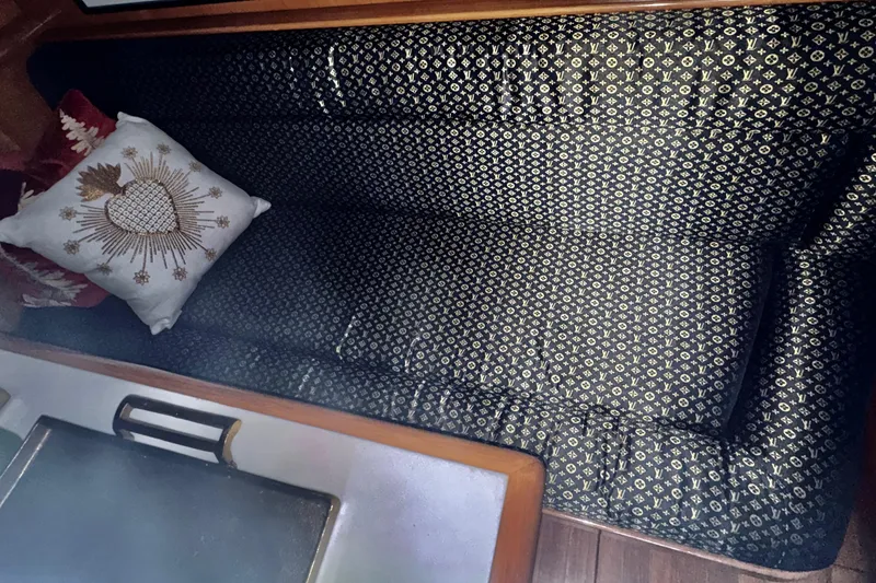 Slide: The Image of 1988 Carmague 48 CPMY interior with patterned seating and decorative pillow. - 17