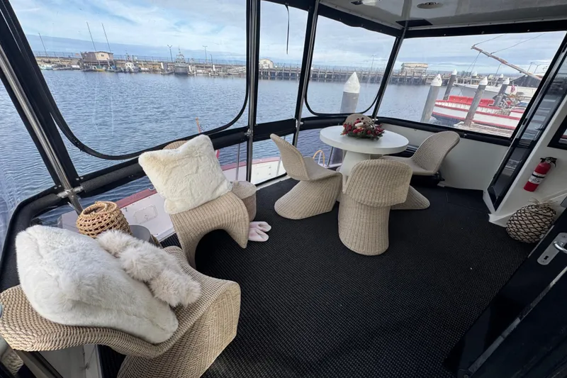 Slide: The Image of Luxurious 1988 Carmague 48 CPMY yacht interior with cozy seating and waterfront view. - 28
