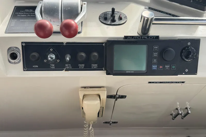 Slide: The Image of Control panel of a 1988 Carmague 48 CPMY yacht with autopilot and communication equipment. - 32