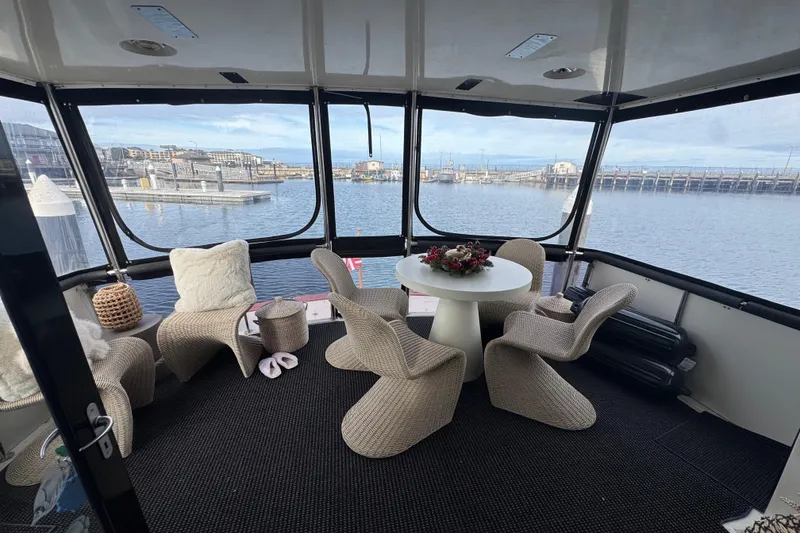 Slide: The Image of Luxurious 1988 Carmague 48 CPMY yacht interior with elegant seating and waterfront view. - 37