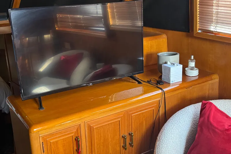 Slide: The Image of Interior of 1988 Carmague 48 CPMY with TV, wooden cabinet, and cozy seating. - 4