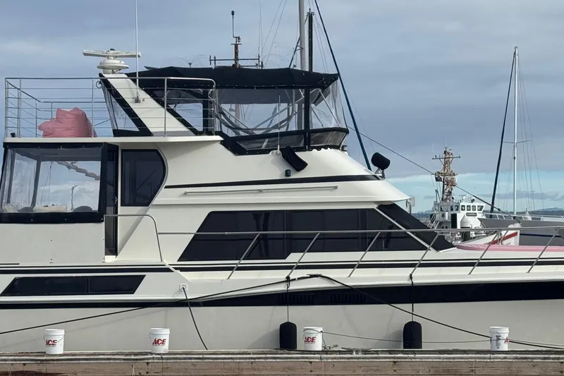 Slide: The Image of 1988 Carmague 48 CPMY yacht docked at marina, side view with clear sky. - 42