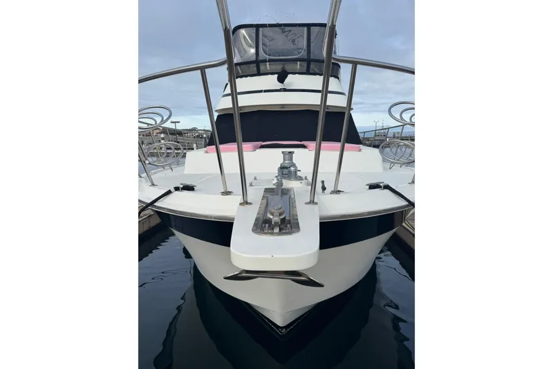 Slide: The Image of 1988 Carmague 48 CPMY yacht docked, showcasing sleek design and polished metal features. - 43