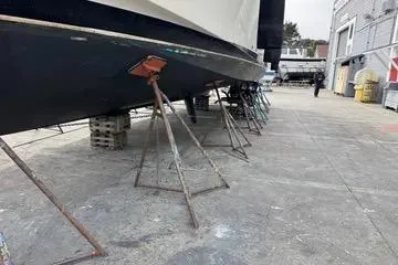 Slide: The Image of 1988 Camargue 48 CPMY yacht on stands in a boatyard for maintenance. - 48