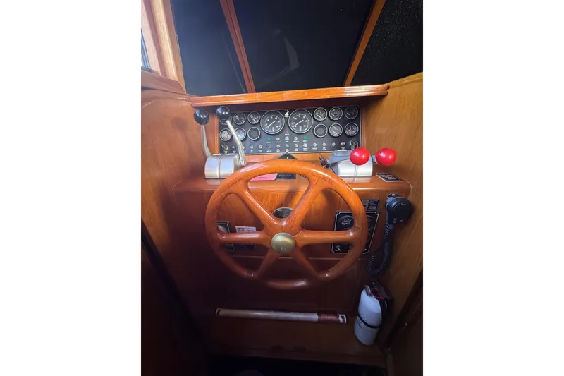 Slide: The Image of 1988 Carmague 48 CPMY helm with wooden steering wheel and control panel. - 5