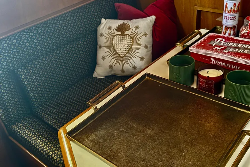 Slide: The Image of Cozy 1988 Carmague 48 CPMY interior with decorative pillows, candles, and peppermint bark. - 8