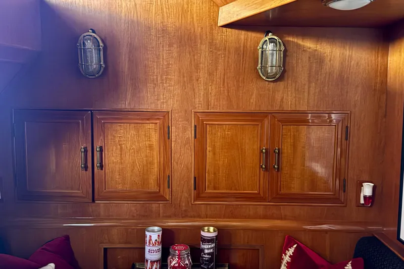 Slide: The Image of 1988 Carmague 48 CPMY yacht interior with wooden cabinets and nautical lighting. - 9