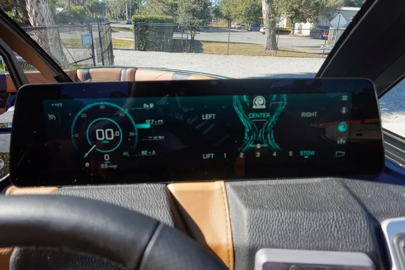 Slide: The Image of 2026 Malibu Wakesetter 23 LSV dashboard display with digital controls and speedometer. - 24