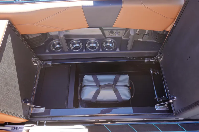 Slide: The Image of 2026 Malibu Wakesetter 23 LSV storage compartment with bag, tan and black interior. - 28