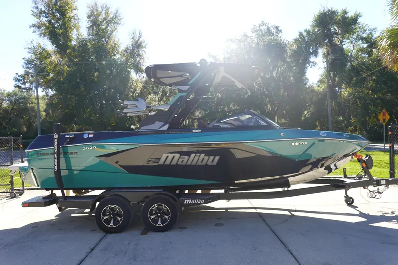 Slide: The Image of 2026 Malibu Wakesetter 23 LSV boat on trailer, parked outdoors in sunlight. - 3