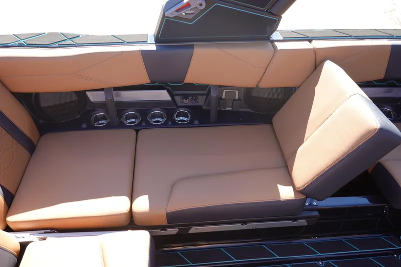 Slide: The Image of 2026 Malibu Wakesetter 23 LSV interior seating with tan upholstery and cup holders. - 30