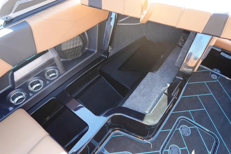Slide: The Image of 2026 Malibu Wakesetter 23 LSV interior storage and seating area with cup holders. - 31