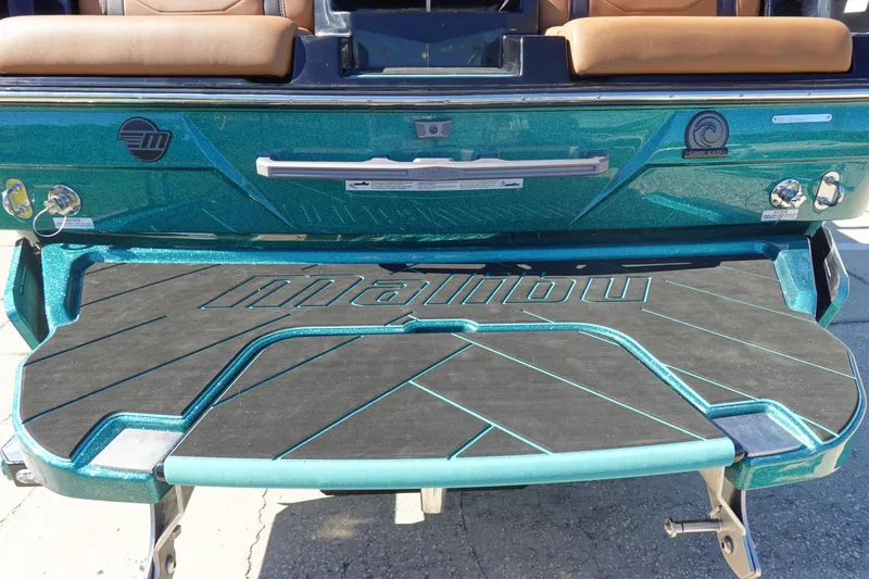 Slide: The Image of 2026 Malibu Wakesetter 23 LSV boat rear view with teal detailing. - 4