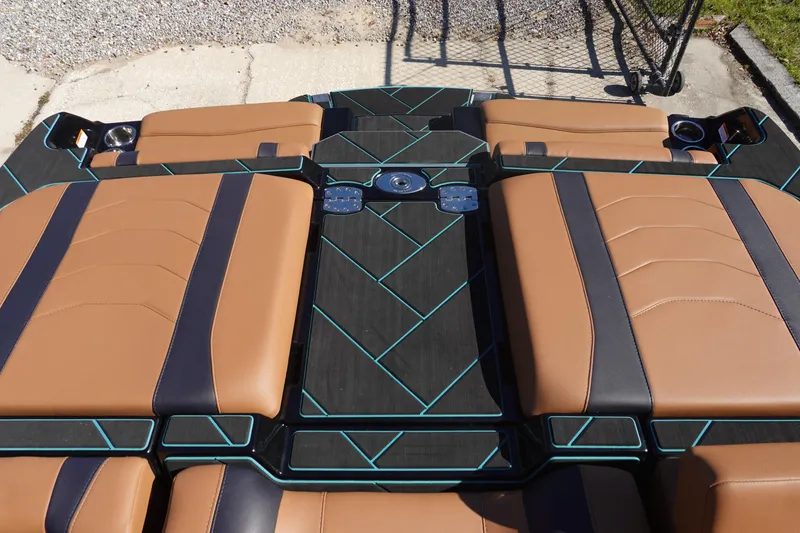 Slide: The Image of 2026 Malibu Wakesetter 23 LSV boat interior with tan and black seating, teal accents. - 46