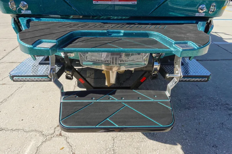 Slide: The Image of 2026 Malibu Wakesetter 23 LSV swim platform with teal accents and step ladder. - 5