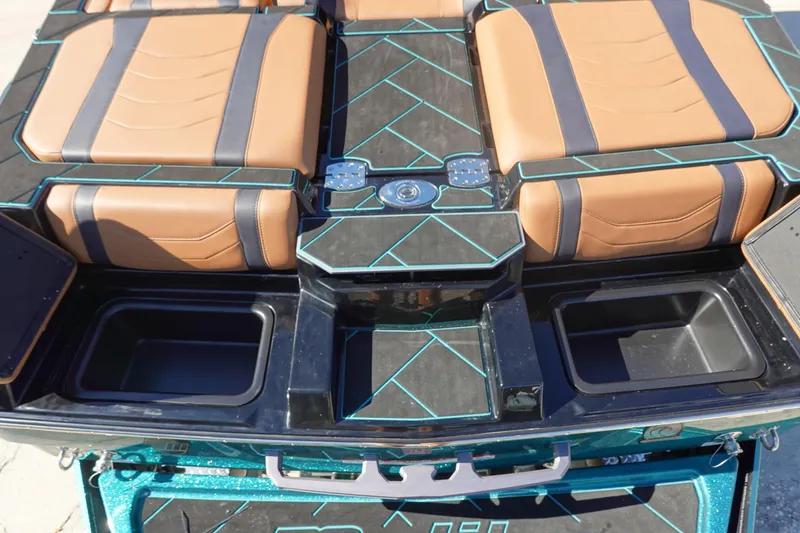 Slide: The Image of 2026 Malibu Wakesetter 23 LSV interior with tan and black seating, teal accents, and storage compartments. - 9