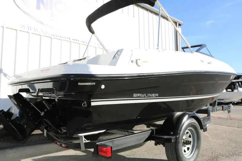 Slide: The Image of 2009 Bayliner VR4 Bowrider I/O boat on trailer, black and white exterior. - 10