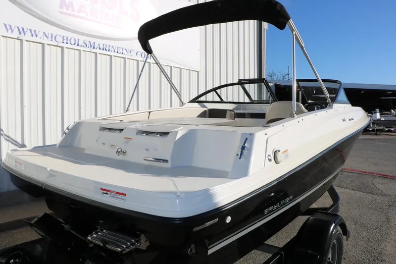 Slide: The Image of 2009 Bayliner VR4 Bowrider I/O boat with black and white exterior, parked outdoors. - 11