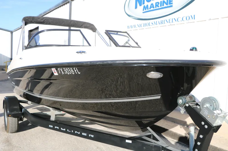 Slide: The Image of 2009 Bayliner VR4 Bowrider I/O on trailer, black hull, parked at Nichols Marine. - 12