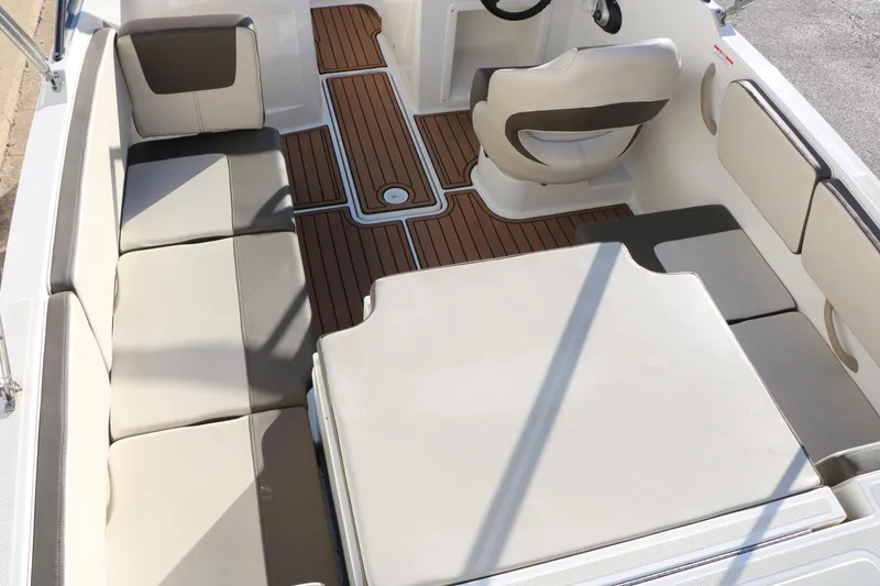 Slide: The Image of 2009 Bayliner VR4 Bowrider I/O interior with beige seating and wood-style flooring. - 16