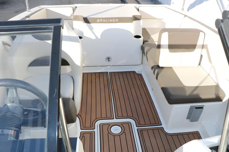 Slide: The Image of 2009 Bayliner VR4 Bowrider I/O interior with cushioned seating and wood-patterned flooring. - 21