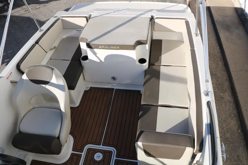 Slide: The Image of 2009 Bayliner VR4 Bowrider I/O interior with beige seating and wood-style flooring. - 25