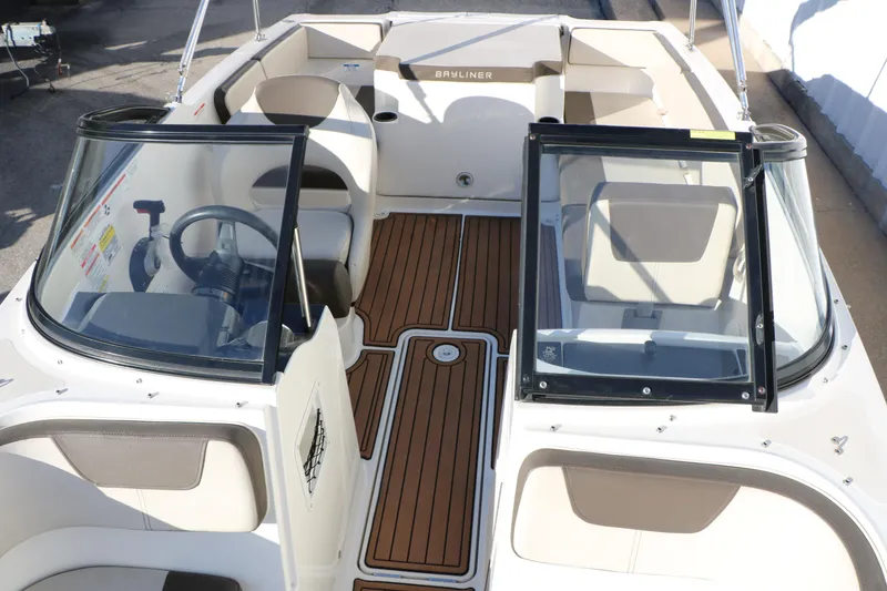 Slide: The Image of 2009 Bayliner VR4 Bowrider I/O interior with seating and steering wheel, featuring wood-style flooring. - 26