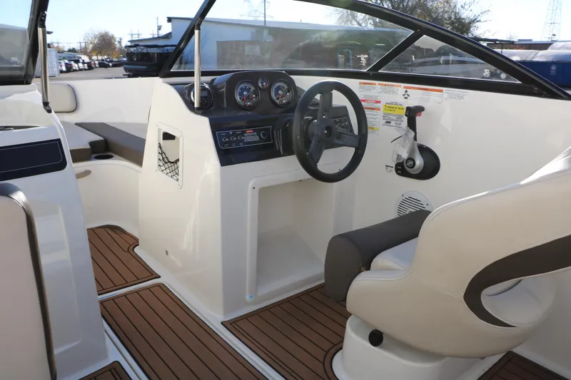 Slide: The Image of 2009 Bayliner VR4 Bowrider I/O interior with steering wheel and dashboard controls. - 27