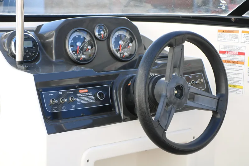 Slide: The Image of 2009 Bayliner VR4 Bowrider I/O dashboard with steering wheel and gauges. - 28