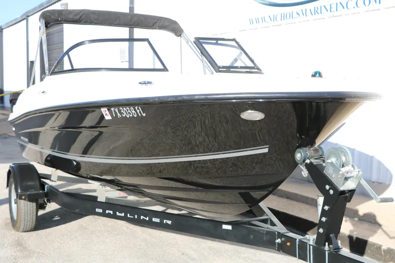 Slide: The Image of 2009 Bayliner VR4 Bowrider I/O on trailer, black and white exterior, parked outdoors. - 5