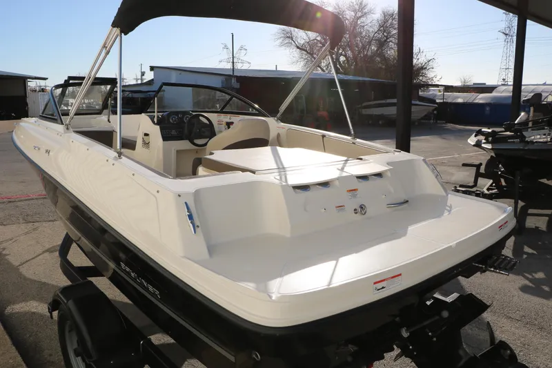 Slide: The Image of 2009 Bayliner VR4 Bowrider I/O boat with canopy, parked outdoors on a trailer. - 7
