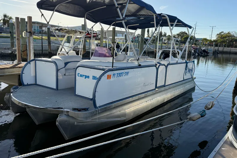 The Image of 2021 Aloha Pontoon Tropical Series 23 docked at marina with canopy. - 0