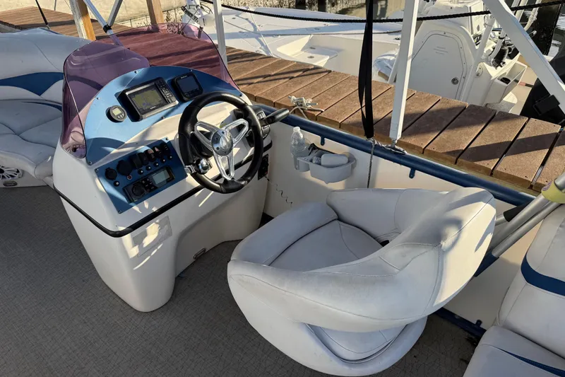 Slide: The Image of Captain's helm of 2021 Aloha Pontoon Tropical Series 23 with steering wheel and controls. - 10