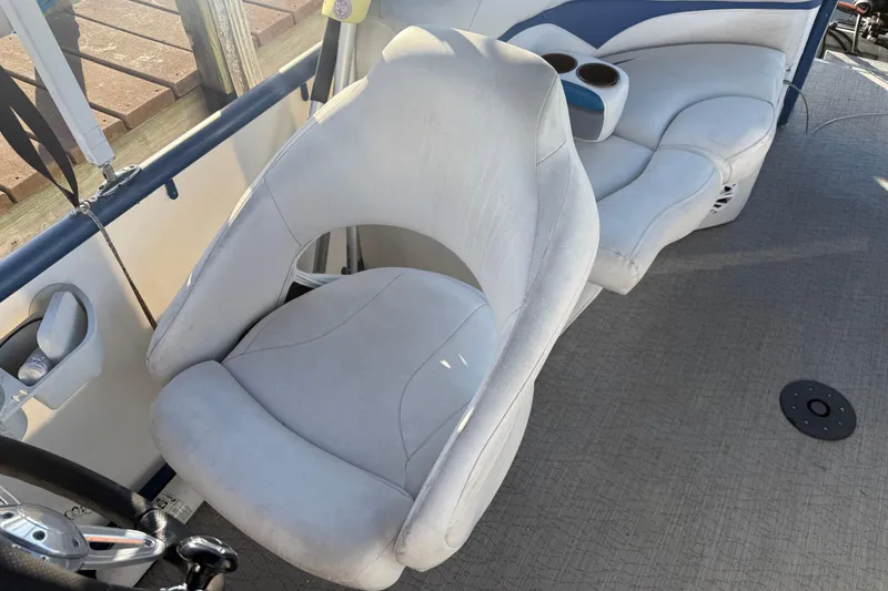 Slide: The Image of 2021 Aloha Pontoon Tropical Series 23 interior with plush seating and cup holders. - 11