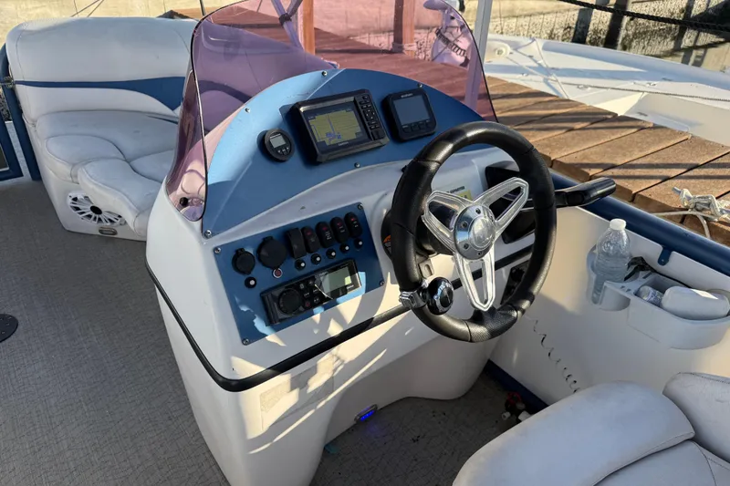 Slide: The Image of Cockpit of 2021 Aloha Pontoon Tropical Series 23 with steering wheel and control panel. - 12