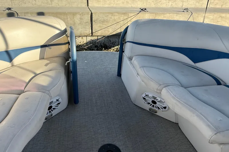 Slide: The Image of 2021 Aloha Pontoon Tropical Series 23 interior with cushioned seating and speakers. - 18