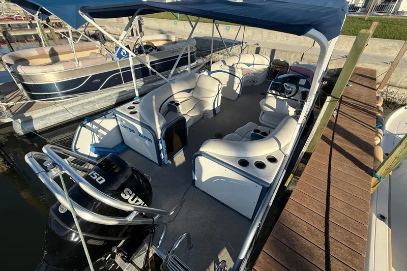 Slide: The Image of 2021 Aloha Pontoon Tropical Series 23 docked, featuring spacious seating and a Suzuki 150 engine. - 3