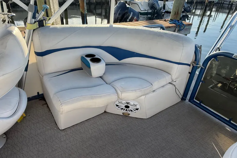 Slide: The Image of 2021 Aloha Pontoon Tropical Series 23 interior seating with cup holders and speaker. - 6
