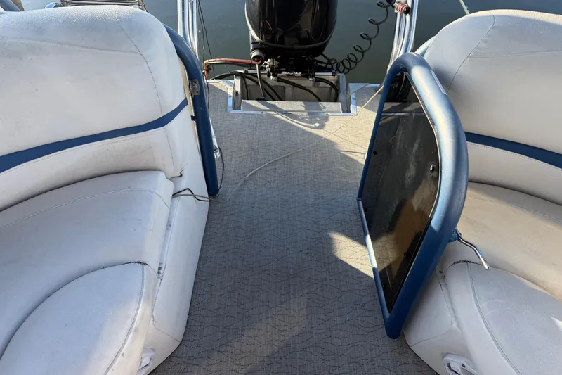 Slide: The Image of Interior view of 2021 Aloha Pontoon Tropical Series 23 with white seating and blue accents. - 7