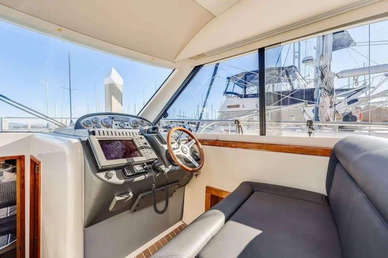 Slide: The Image of Interior view of 2007 Riviera boat cockpit with steering wheel and navigation equipment. - 10