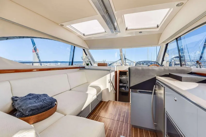 Slide: The Image of Luxurious 2007 Riviera yacht interior with modern seating, kitchen, and panoramic windows. - 11