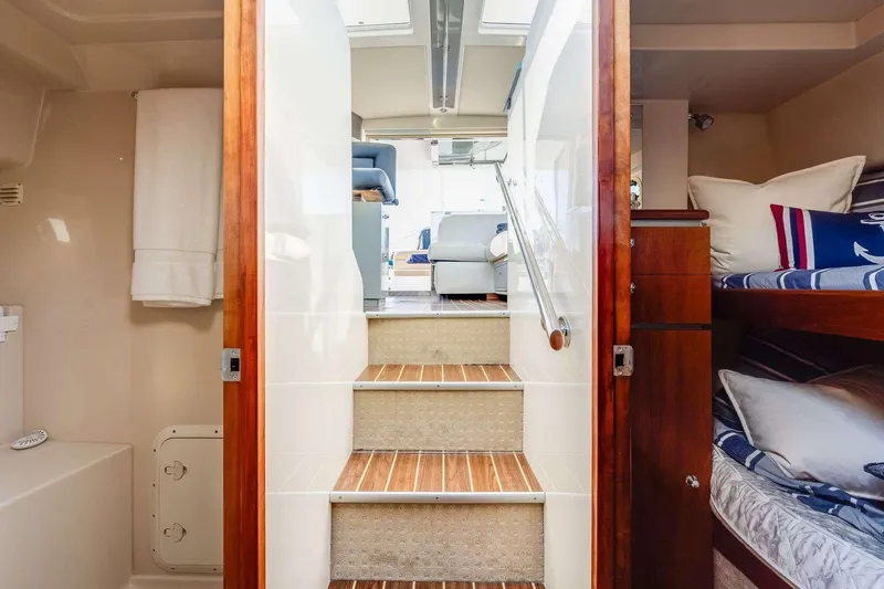Slide: The Image of Interior of 2007 Riviera yacht with stairs, bunk beds, and modern decor. - 14