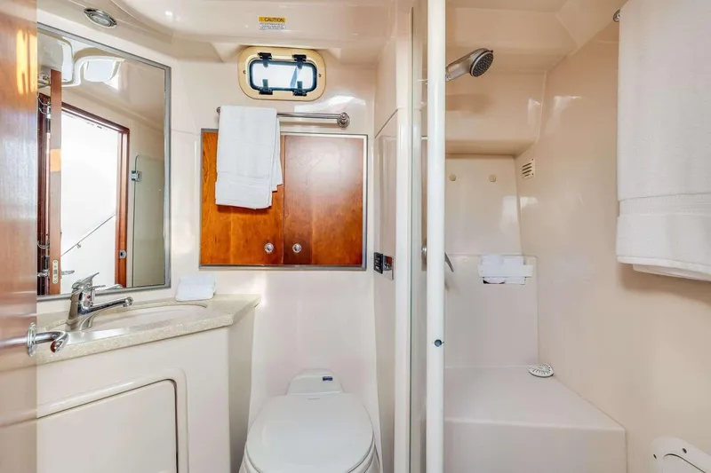 Slide: The Image of Luxurious 2007 Riviera yacht bathroom with shower, sink, and wooden cabinets. - 17