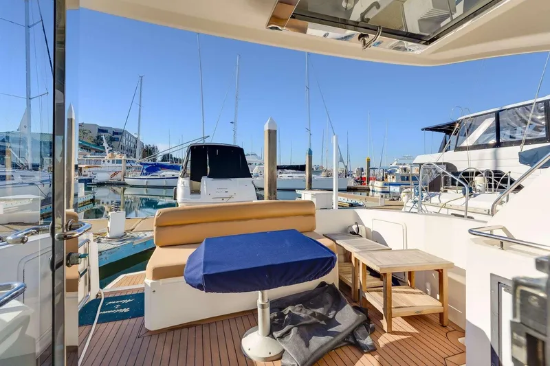 Slide: The Image of 2007 Riviera boat interior with seating area, docked at a marina under clear blue skies. - 21