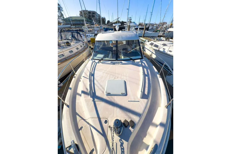 Slide: The Image of 2007 Riviera boat docked among sailboats in a marina. - 22