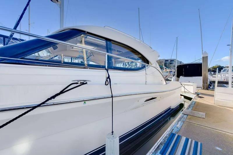 Slide: The Image of 2007 Riviera yacht docked at marina, showcasing sleek design and modern features. - 24