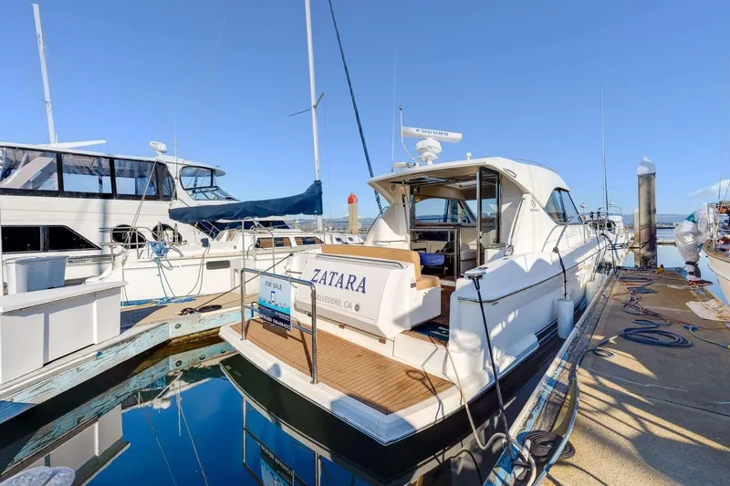 Slide: The Image of 2007 Riviera yacht docked at marina, for sale sign visible. - 26