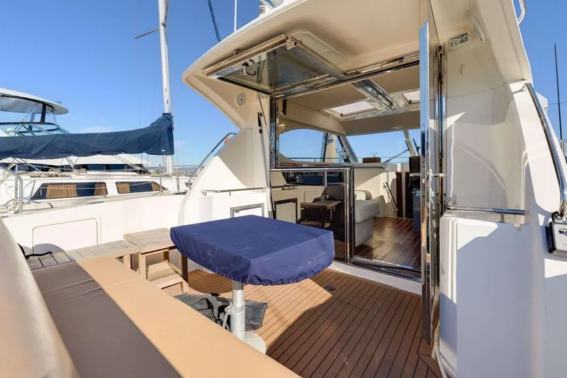 Slide: The Image of 2007 Riviera yacht with open deck, covered seating, and luxurious interior view. - 4