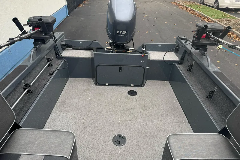 Slide: The Image of 2022 Duckworth 18 Advantage Sport boat interior with motor and fishing rod holders. - 13