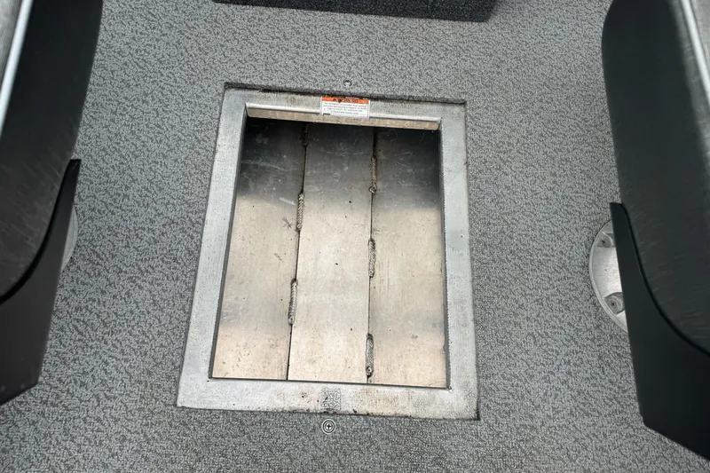 Slide: The Image of 2022 Duckworth 18 Advantage Sport boat floor compartment, gray carpeted interior. - 21